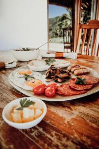 a plate of food sitting on a wooden table at Stanley Island in Plettenberg Bay