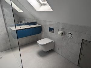 a bathroom with a toilet and a sink at The Nest at Fairfield in Wargrave