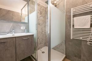 a bathroom with a shower and a sink at [IHost Luxury Flat Bormio] - Centrale 69 in Piatta