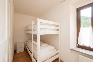 a white bunk bed in a room with a window at [IHost Luxury Flat Bormio] - Centrale 69 in Piatta