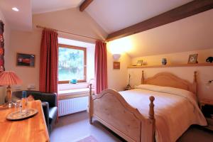a bedroom with a large bed and a window at High Trenhouse in Settle