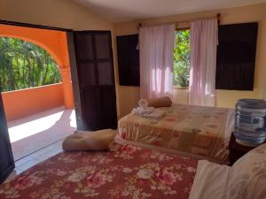 Ein Bett oder Betten in einem Zimmer der Unterkunft Casa Iguana