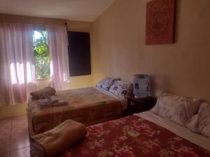 Ein Bett oder Betten in einem Zimmer der Unterkunft Casa Iguana