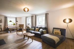 ein Wohnzimmer mit einem Sofa und einem Tisch in der Unterkunft Ferienhaus Chalet an der Brettach in Gerabronn