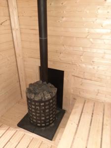 a fireplace in a room with a trash can at Odsapka u Agi in Wydminy