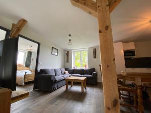 a living room with a couch and a table at Au clos du seltzbach in Hoffen