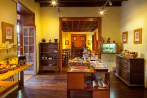 a kitchen with yellow walls and wooden floors at Hotel LIVVO La Quinta Roja in Garachico +25 photos