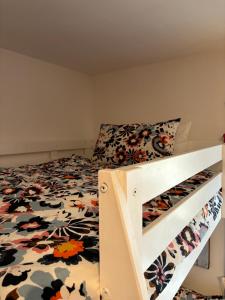 a bedroom with a bed with a floral bedspread at White Love Versilia in Viareggio