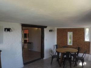 a dining room with a table and chairs at San Miguel del monte 6 personas con pileta in San Miguel del Monte