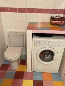 a bathroom with a toilet and a washing machine at White Love Versilia in Viareggio