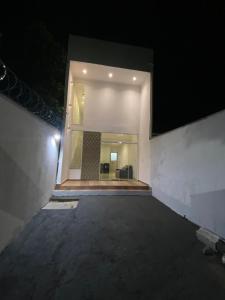 an empty room with a large window at night at Casa praia 99 in Serra