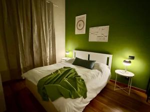 a green bedroom with a bed with a green wall at La Madama Cristina in Turin
