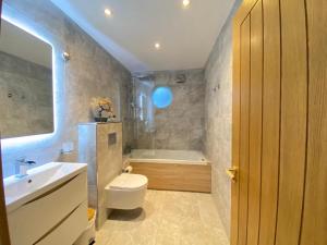 a bathroom with a toilet and a sink and a tub at Lake District cottage in 1 acre gardens off M6 in Penrith +56 photos