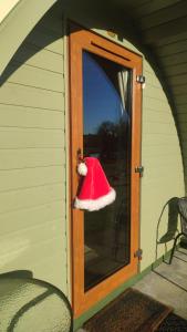 a santa hat is hanging on a door at Glamping Pod Thady Killynick County Fermanagh in Killyhevlin