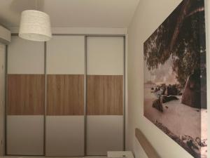 a room with glass doors and a painting on the wall at Apartment VacationVibes Mostar in Mostar