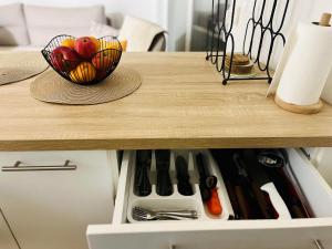 a table with a bowl of apples and a hat on it at Apartment VacationVibes Mostar in Mostar +9 photos
