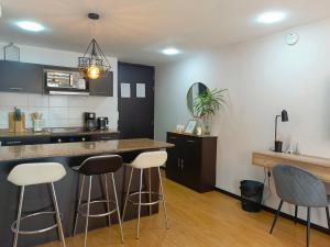 uma cozinha com bancos de bar e um balcão em Like a Home with Balcony - 7Th FLOOR - Parking - Gym em Quito