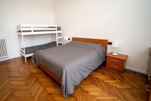 コルマーノにあるAG apartmentのウッドフロアのベッドルーム1室(二段ベッド1組付)