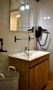 a bathroom with a sink and a mirror at A Muralha in Porto