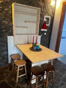 a wooden table with four stools and a table with at Chalet Karpenisi in Karpenisi