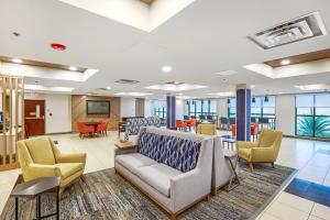 a waiting room at a hospital with chairs and tables at Holiday Inn Express - Gulfport Beach by IHG in Gulfport