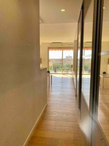 an empty hallway of a house with a view of a pool at Cocon ensoleillé avec parking gratuit in Nice