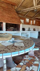 a large room with a table and a fireplace at Cabaña del mirador in Villa Parque Siquiman