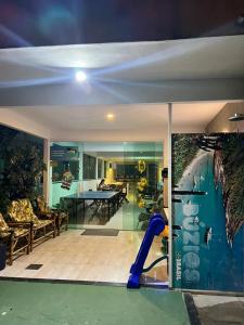 a house with a swimming pool and a play room at Pousada Portico de Buzios in Armacao dos Buzios