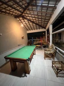 a ping pong table in a room with a pool table at Pousada Portico de Buzios in Armacao dos Buzios