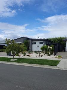 a house with a garden in front of it at Chappie's Place in Motueka