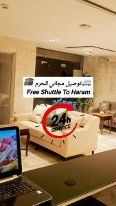 a living room with a white couch and a laptop at فندق اسكان وافر متوفر توصيل مجاني للحرم على مدار 24 ساعة in Makkah