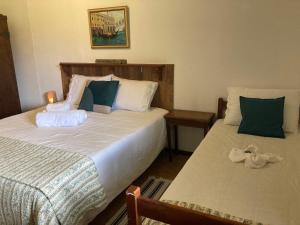 a bedroom with two beds at ÉCOisa de Chácara - Casa de Vidro, Casa de Campo in Morretes