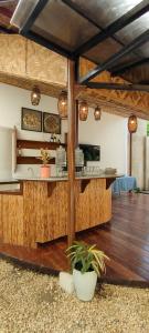 a kitchen with a bar in a room with wooden floors at Intoy's Place in Panglao Island
