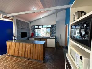 a kitchen with a bar in the middle of a room at Ilha azul hospedagem in Florianópolis