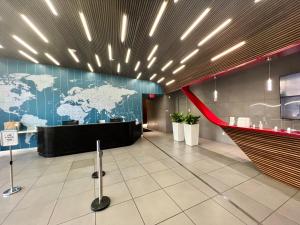 a lobby with a map of the world on the wall at MVR Apartments at Beachwalk Resort in Hallandale Beach