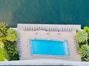 an overhead view of a swimming pool next to the water at MVR Apartments at Beachwalk Resort in Hallandale Beach