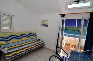 salon z kanapą i balkonem w obiekcie Apartments Livia w mieście Lastovo