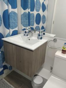 a bathroom with a sink and a toilet at Departamento Pucon Condominio Alicura in Pucón