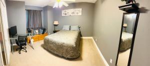 a bedroom with a bed and a desk and a mirror at serenity in Fresno