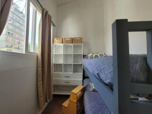 a bedroom with a bed and a dresser and a window at Sueño Maipú in Mar del Plata