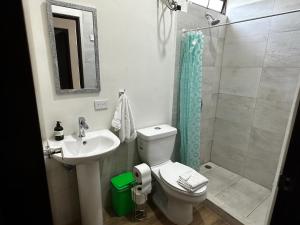 a bathroom with a toilet and a sink and a shower at Peaceful Apartment in Tamarindo, 50m to the Beach - Sofia Apartments in Tamarindo