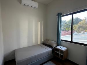 um pequeno quarto com uma cama e uma janela em Peaceful Apartment by the Langosta Beach em Tamarindo