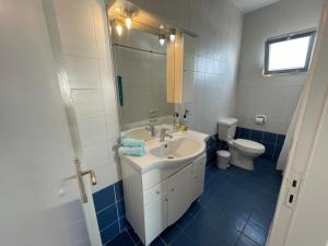 a bathroom with a sink and a toilet at Pissouri Beach Apartments in Pissouri