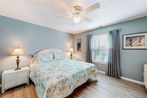 a bedroom with a bed and a ceiling fan at Ocean City Townhome by Beach Bayside in Ocean City