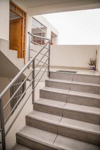 a set of stairs in a building with a door at Lujoso Departamento ,Iluminado , 5 minutos Centro in Tacna