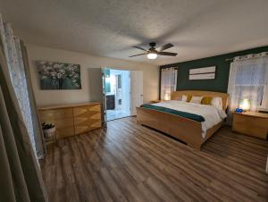 a bedroom with a bed and a ceiling fan at Modern Luxe Family & Groups Friendly Bungalow with Patio & Workspace in Marietta