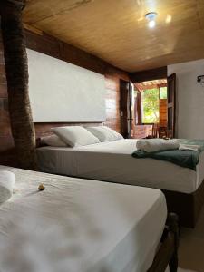 two beds in a room with two beds sidx sidx sidx at Pousada Coral Negro in Jericoacoara