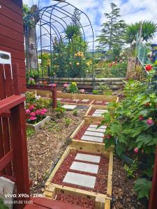 un jardín con flores y un invernadero en Private Large double room, en Auckland