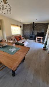 a living room with a couch and a table at CUNCUMEN Caviahue in Caviahue