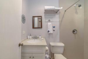 a white bathroom with a toilet and a sink at Cozy Corner (Mercy's Place) in Buckleys